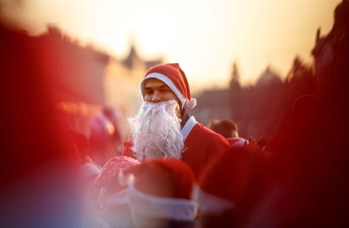 A young man dressed as Santa Claus
