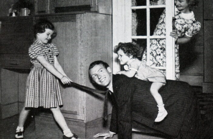 Brother and sister playing with their father. Illustration in a newspaper of family life in Britain in the 1950s
