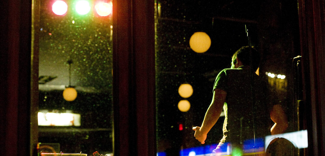 A man takes the stage for karaoke at the Gladstone Hotel