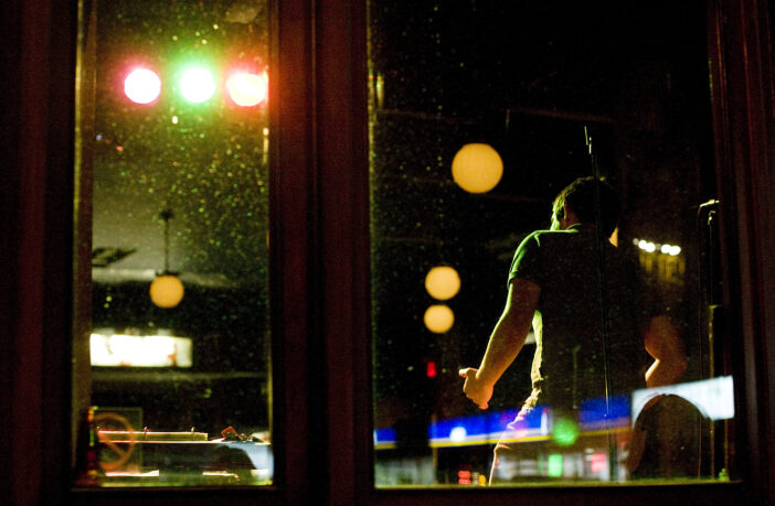 A man takes the stage for karaoke at the Gladstone Hotel