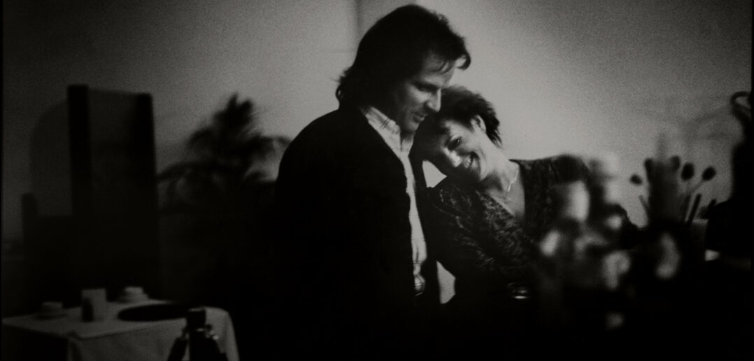 View of an unidentified couple, the woman smiling and leaning her head on the shoulder of her companion, at an unspecified club, Vallejo, California,