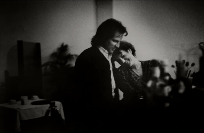 View of an unidentified couple, the woman smiling and leaning her head on the shoulder of her companion, at an unspecified club, Vallejo, California,